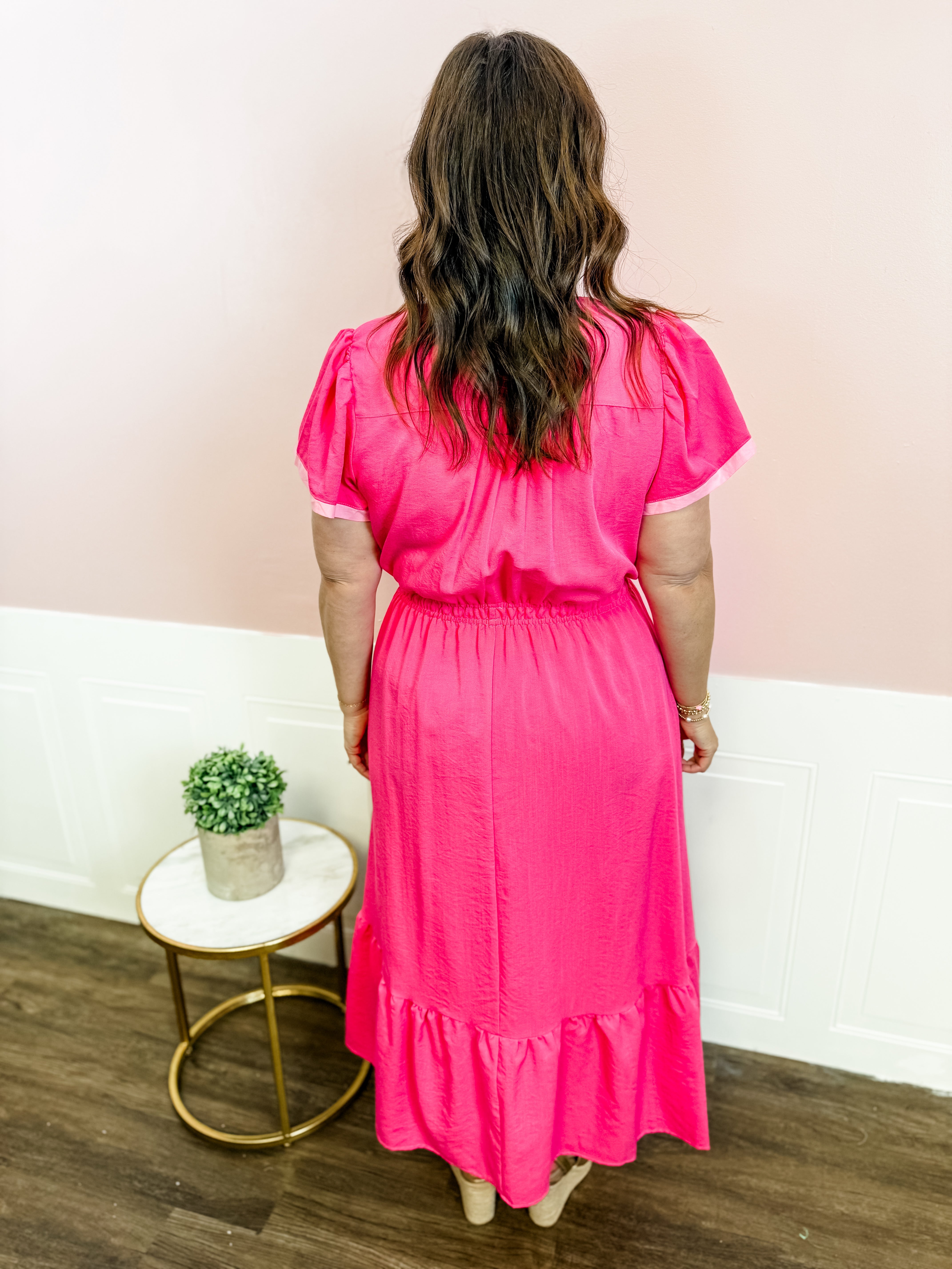 woman in a pink dress PS22158 6 / Hot * Ruched bodycon silhouette * Cowl halter neckline with tie fastening * Mesh bust cutout detail * Long bell sleeves * Moderate stretch fabric Style Tip Karianne Draped Ruched Bodice Gown